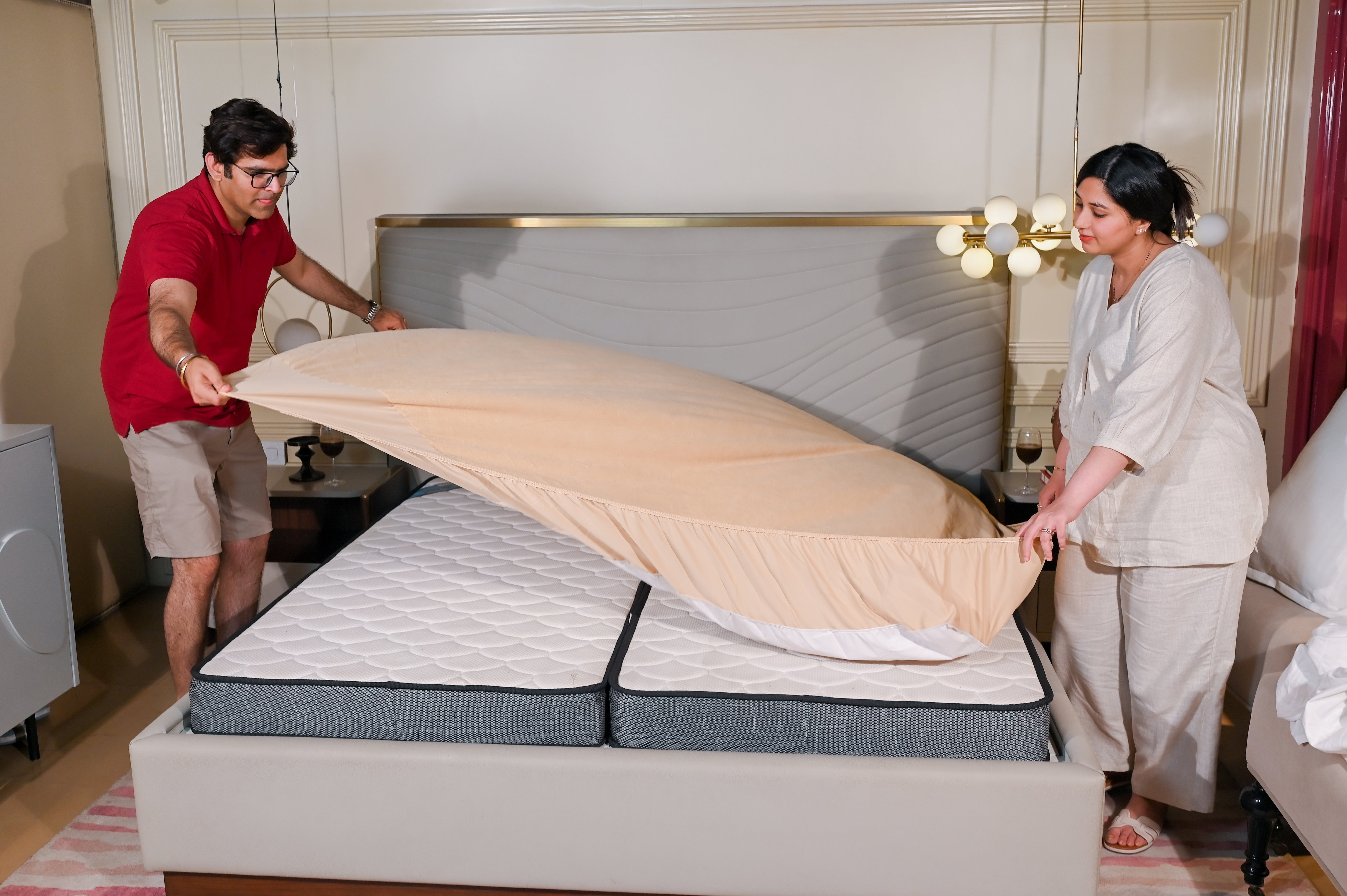 Stretch the elastic corners over your mattress, just like you would do with a fitted sheet. Make sure it sits evenly and snugly across all sides for a smooth, wrinkle-free finish.